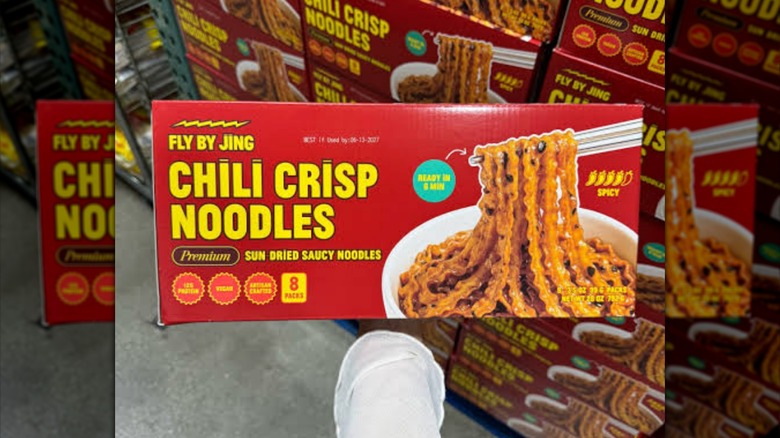 Box of Fly By Jing Chili Crisp Noodles held at Costco