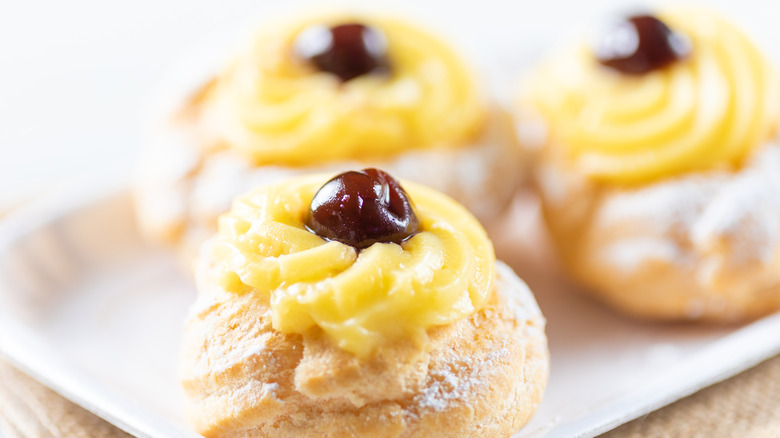 Several zeppole pastries on a white plate