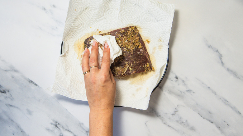 Patting steak dry.