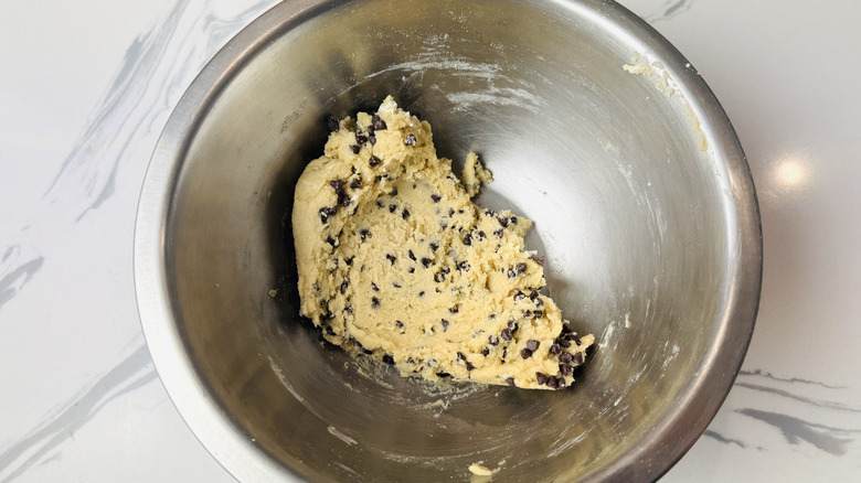 Cookie dough with chocolate chips in a mixing bowl