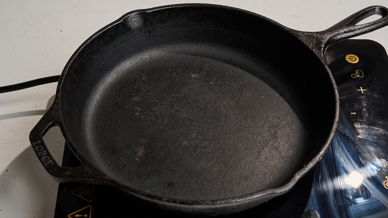 heating a cast iron skillet on a stove