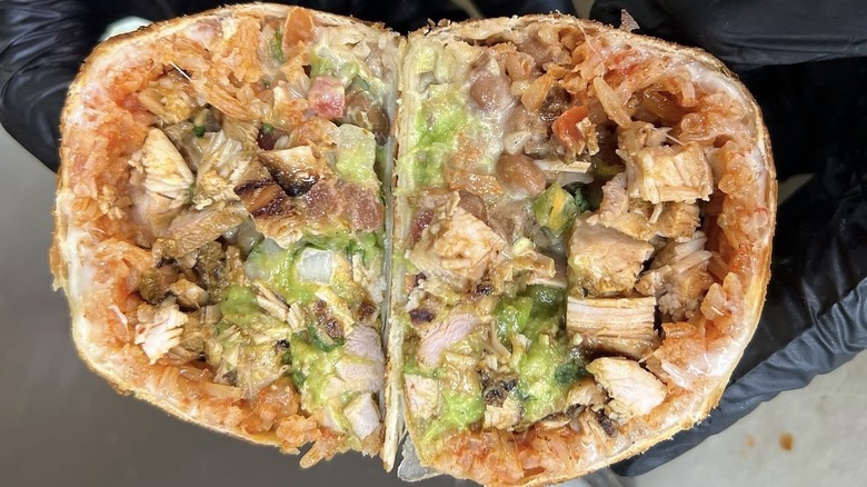 Burrito with chicken, pinto beans, pico de gallo, guacamole, sour cream, and Monterrey Jack cheese