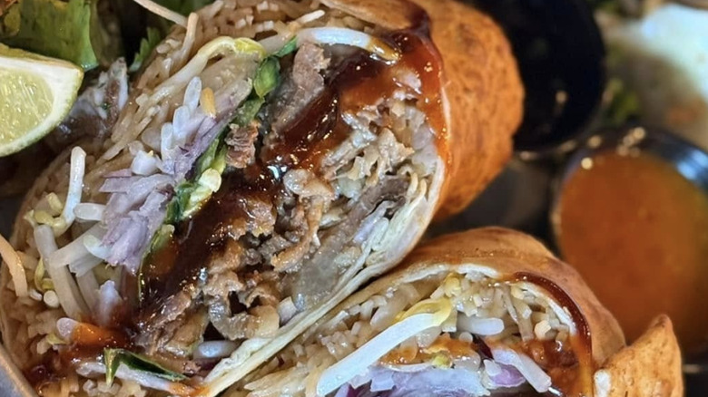 Pho-inspired burrito with rice noodles, bean sprouts, basil, jalapeños, hoisin, and Sriracha