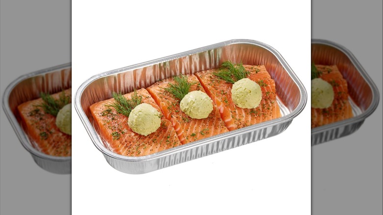 A silver foil tray of Kirkland Signature Salmon Milano with Basil Pesto Butter on display