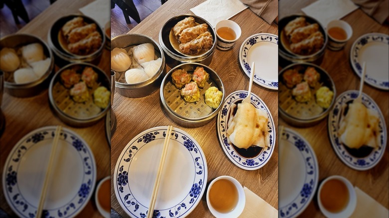 Blue china dishes with Chinese food on a wooden table