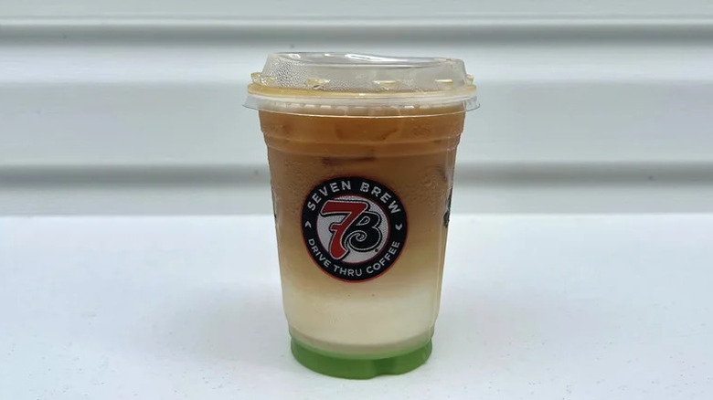 7 Brew Caramel Apple Pie Macchiato on white table in a plastic cup