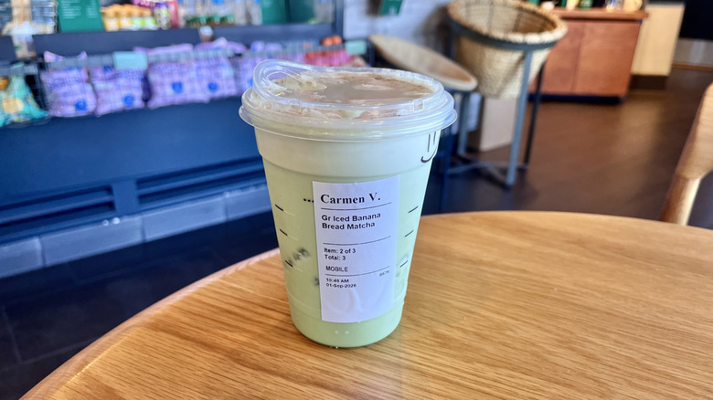 Peet's Coffee Protein Banana Cold Brew Smoothie on a table with a straw inside a plastic cup