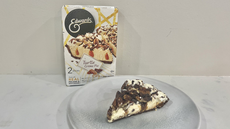 Edwards turtle crème pie slice on a plate in front of the package