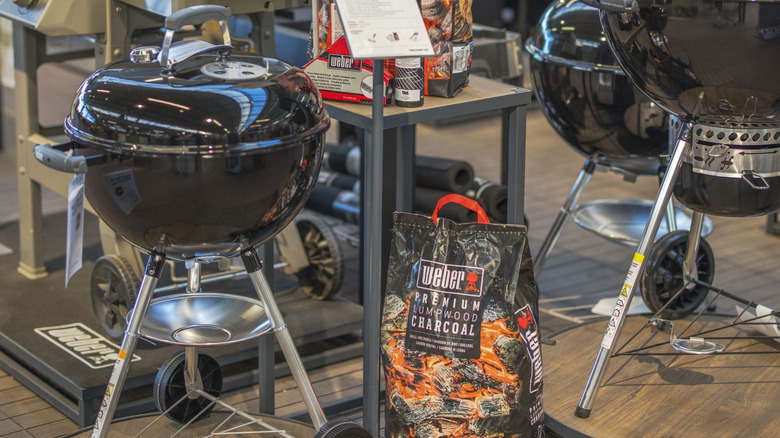 Weber grills and bags of charcoal briquettes