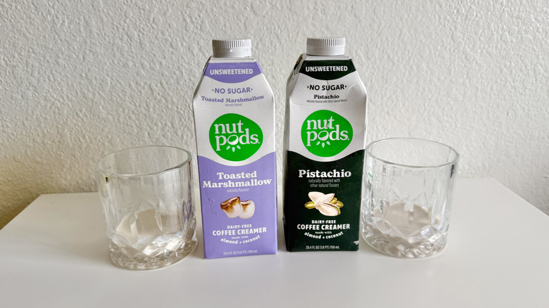 two Nut Pods coffee creamer containers with glasses