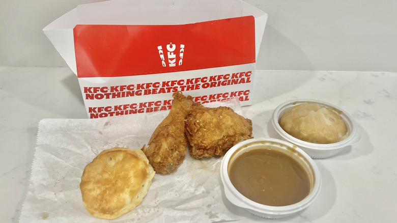 KFC chicken, mashed potatoes, gravy, and biscuit meal.