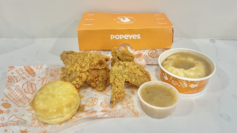 Popeyes chicken, mashed potatoes, gravy, and biscuit meal.