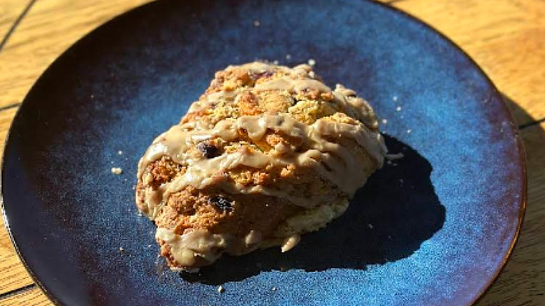 Glazed scone on blue plate at Wild Flour Bread