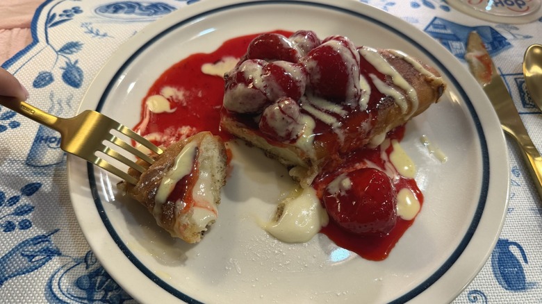 Strawberry french toast cut into and oozing