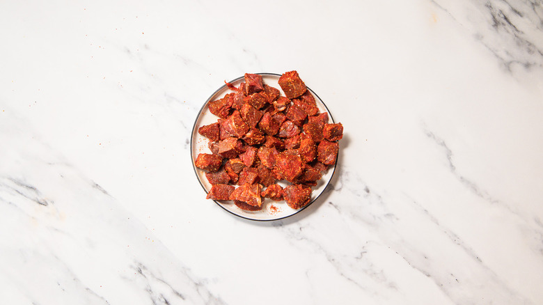 Seasoned steak cubes on plate