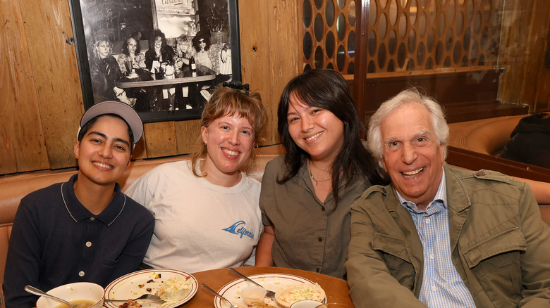 Henry Winkler with fans under the Guns N' Roses photo at Canter's