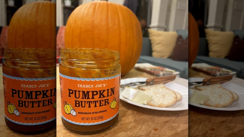 A jar of Trader Joe's pumpkin butter with crackers and cheese
