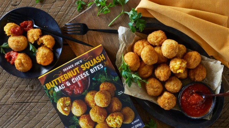Dishes of Trader Joe's Butternut Squash Mac & Cheese Bites served with a red sauce