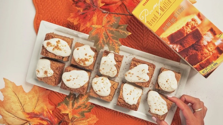 A plate of sliced Trader Joe's pumpkin brad with a creamy topping