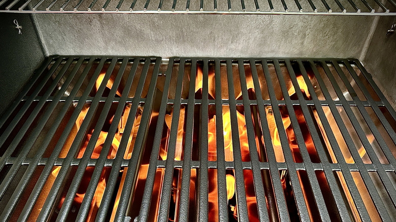 Close up of gas grill grates with flames