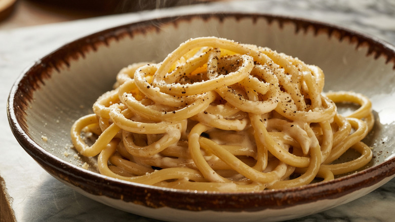 Italian Pici Cacio e Pepe in rustic dish