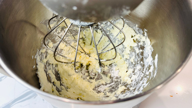 Cream cheese mixture in stand mixer bowl with whisk attachment
