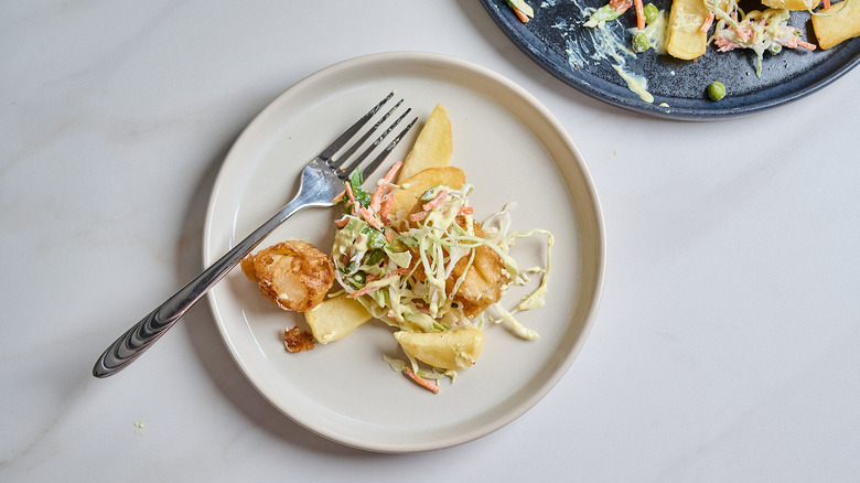 fish and fries on a plate with coleslaw