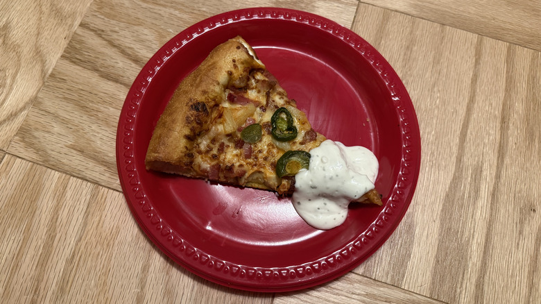 Pizza Hut's Spicy Hawaiian Lover's Pizza slice with ranch.