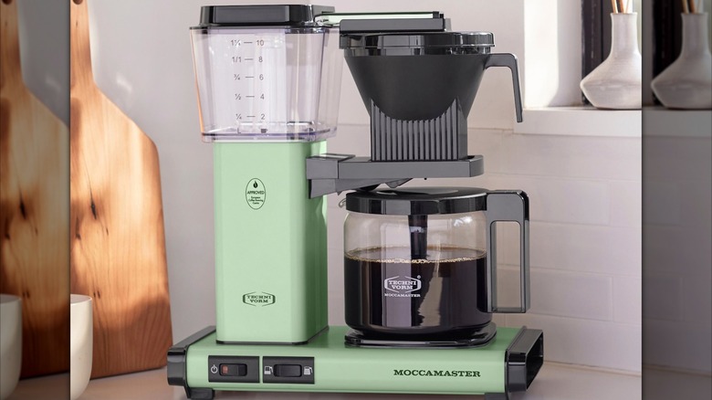 A pistachio green Technivorm Moccamaster KBGV Select Coffee Maker on a kitchen counter