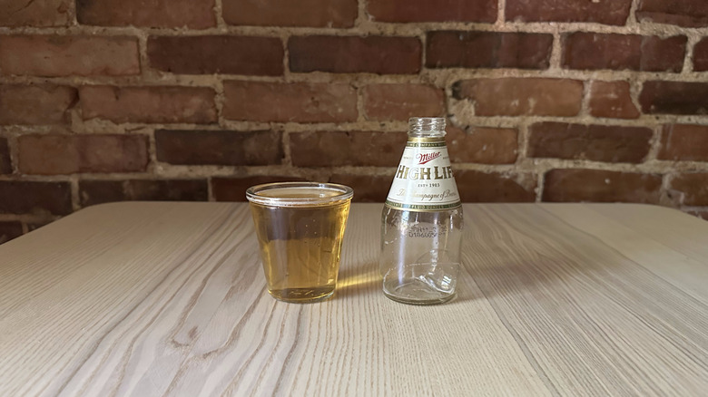 Miller High Life beer in glass on table