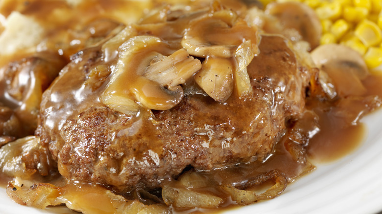 Close up of Salisbury Steak Topped with Sauteed Mushrooms and Onions