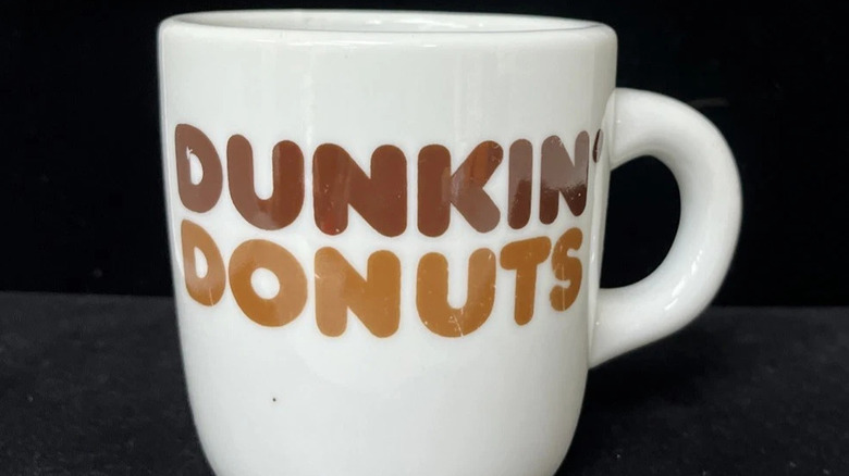 Close up of vintage Dunkin' Donuts mug against dark background