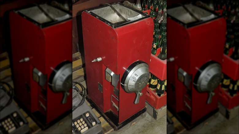 Tall, red vintage coffee grinder machine