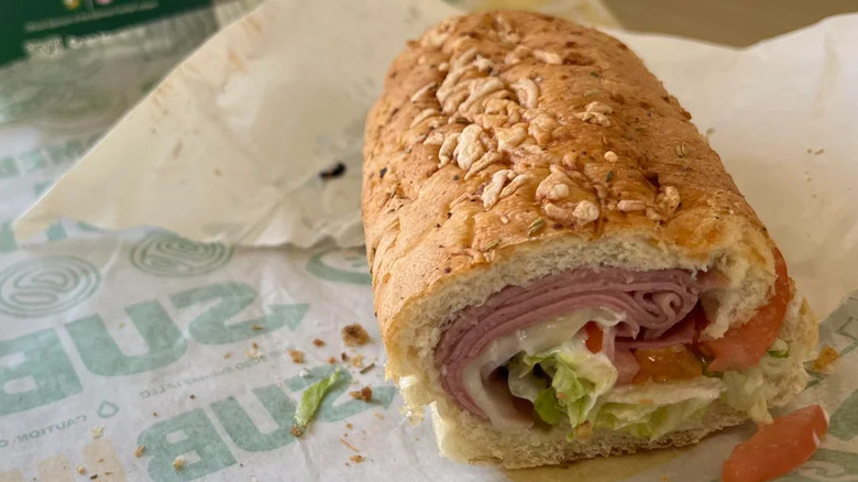 A 6 inch cold cut combo from Subway, showing the cross section with tomato and lettuce visible alongside the meat