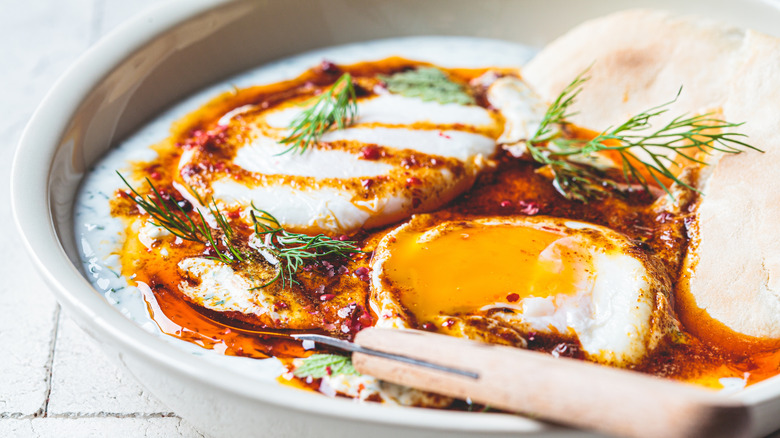 A plate of Turkish eggs with pita bread