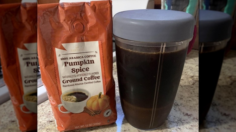 A bag of Aldi Barissimo Pumpkin Spice Ground Coffee next to a container of brewed coffee
