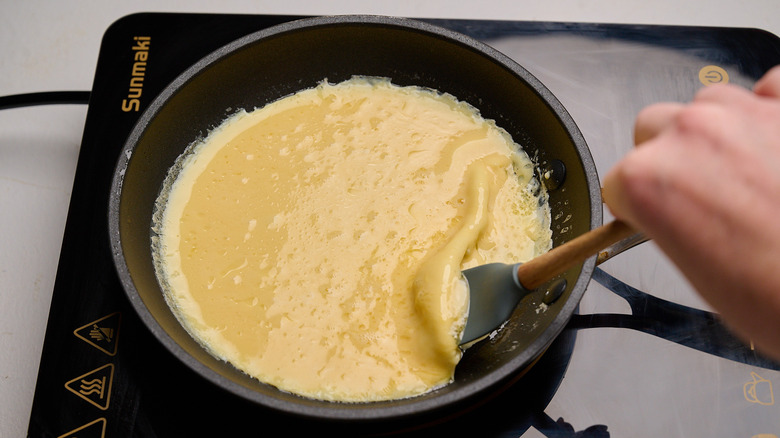 Lifting the side of an omelet with a spatula