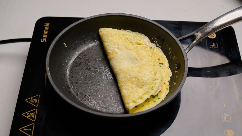 omelet flipped in half on a skillet