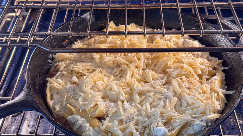Cheese topped pasta skillet in oven