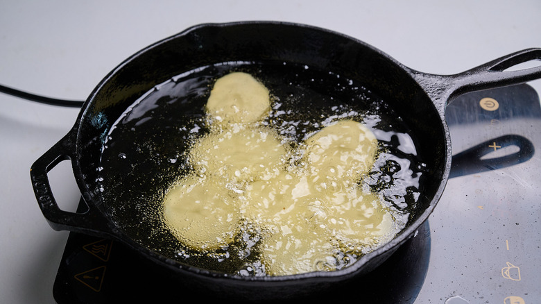 frying potatoes in a skillet