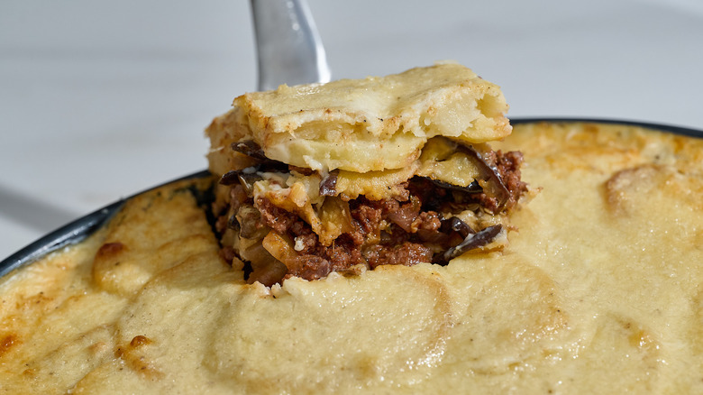 lifting slice of moussaka out of casserole