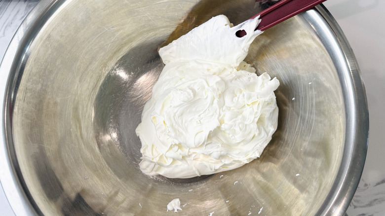 Spatula and whipped cream in bowl
