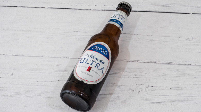 Michelob bottle lying on a white table