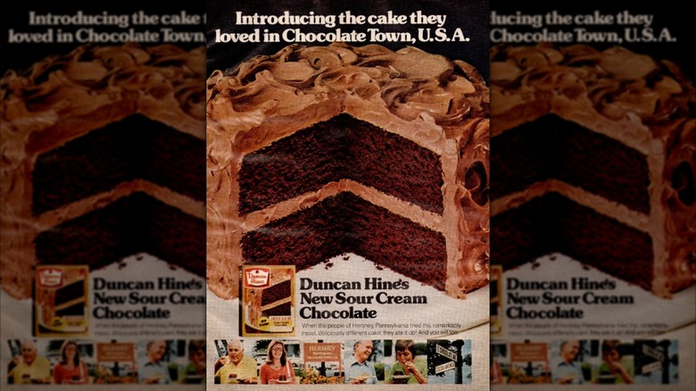 Ad for Duncan Hines Sour Cream Chocolate Cake Mix showing two-tier frosted chocolate cake with slice taken out