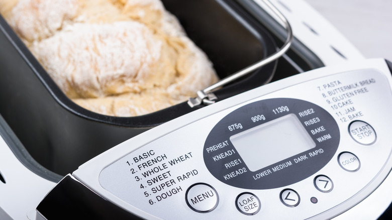 A loaf of bread finished in an opened bread machine.
