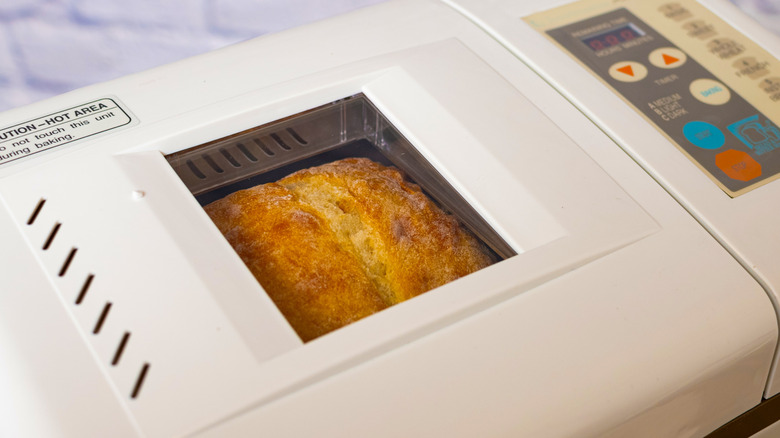 Window of bread maker showing loaf of bread