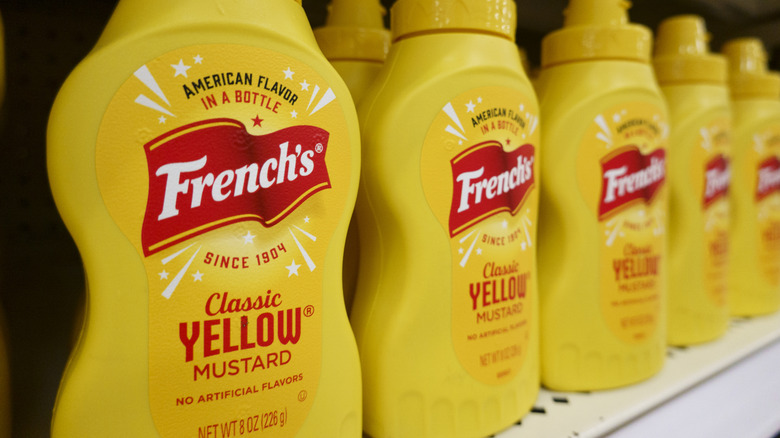 Bottles of French's Classic Yellow Mustard on a store shelf