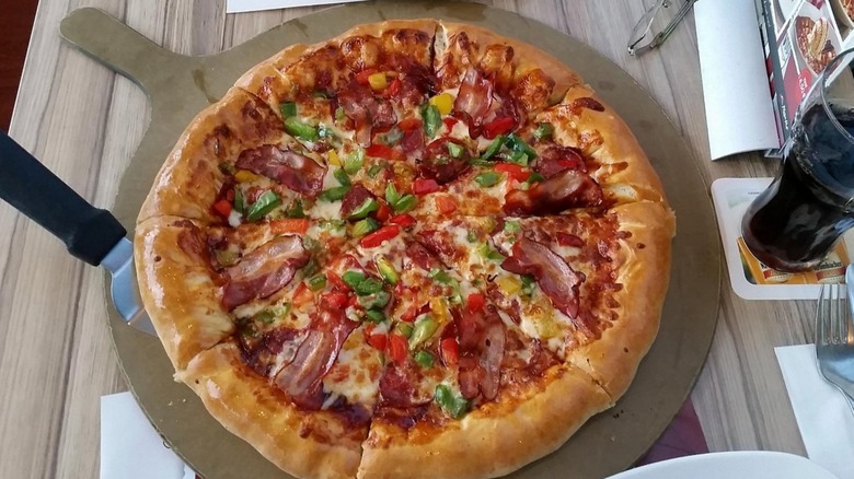 A Texas Supreme pizza on a table at a German Pizza Hut