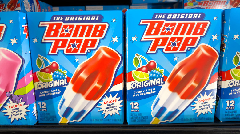 Boxes of original bomb pop lined on a grocery aisle shelf