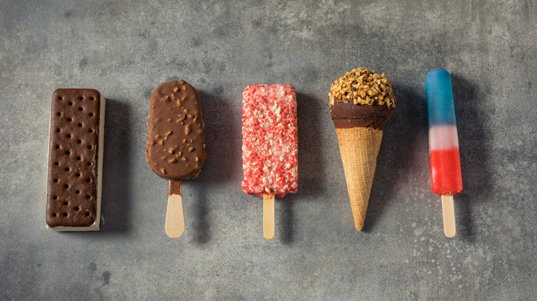 A variety of ice cream novelties on a concrete background